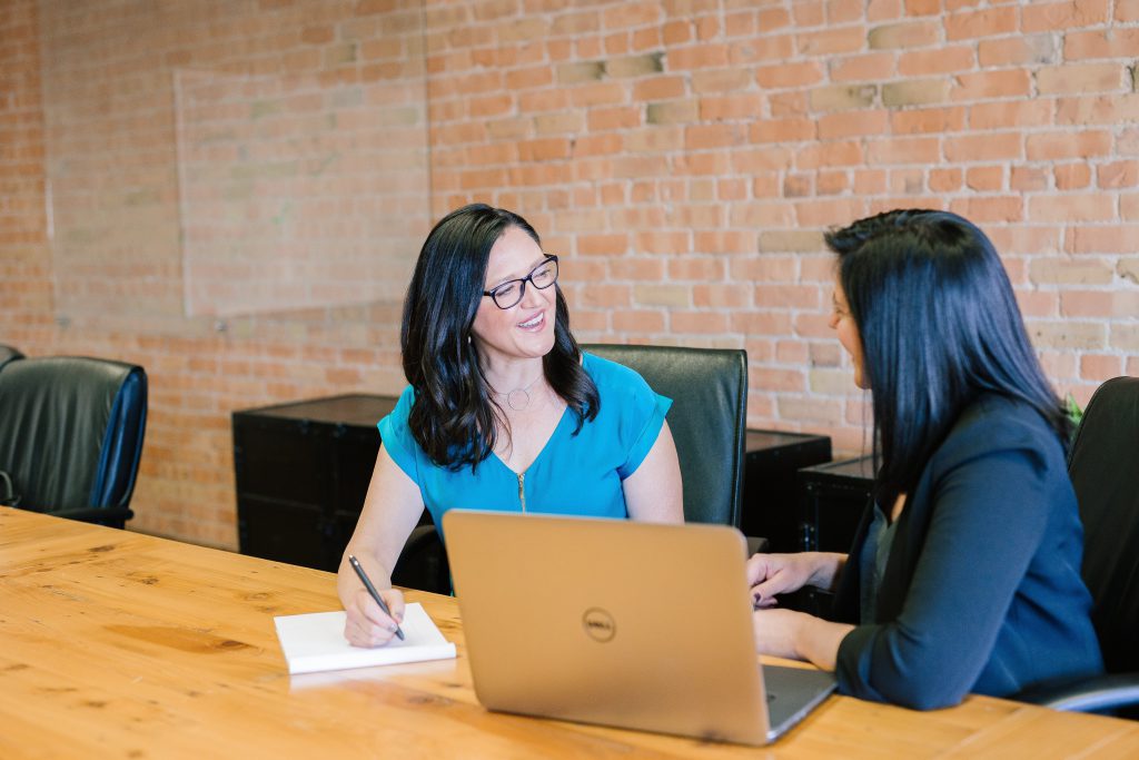 two ladies talking in the office